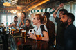 © Zamrznuti tonovi - Diverse fans watching soccer game in a bar