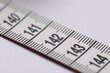 © New Africa - One measuring tape on white background, closeup