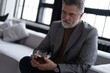 © opolja - Confident mature businessman chilling relaxing drinking enjoying whiskey after work.