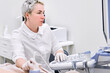 © Maria - Gynecologist doing ultrasound scan in modern clinic