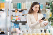 © JackF - Woman in pharmacy scans QR code on paracetamol pills. Health care, healthy lifestyle, prevention. Client learns information about product, reviews and recommendations for use