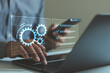 © THAWEERAT - Business process automation concept with digital checklist and gear icons over laptop and smartphone. Workflow management, productivity improvement, task tracking, operational efficiency technology.