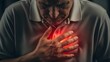 © Artfinity - Chest pain and heart attack symptoms in older adults. Cardiology healthcare and emergency medical care. Senior man clutching his chest with a glowing red pain indicator