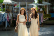 © apichat - Asian women friends shopping in market during summer vacation