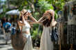© apichat - Happy young women enjoying summer outdoor shopping vacation