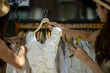 © apichat - Women shopping for clothing at outdoor market stall