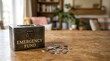 © AlignedArt - Emergency fund savings box with scattered coins on wooden table representing financial security and personal savings planning with copy space