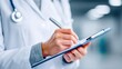 © NovaVision - A doctor in a white coat writes on a clipboard, focusing on medical documentation.