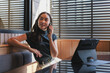 © crizzystudio - Young professional woman communicating on smartphone in modern workspace