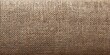© NovaVision - Close-up texture of woven burlap fabric with a natural brown hue and visible fibers