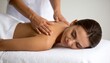 © Marko - Relaxed young lady lying on massage table while therapist's hands work to sooth her muscles, massaging female back