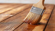 © Bonsales - Paintbrush applying a brown wood stain to wooden planks, creating a protective layer and enhancing natural grain for renovation projects