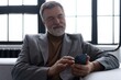 © opolja - Mature smiling man using smartphone