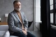 © opolja - Portrait of a confident mature businessman near the window.