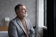 © opolja - Portrait of a confident mature businessman near the window.