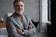 © opolja - Portrait of a confident mature businessman near the window.