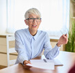 © Lumos sp - Portrait of a mature senior businesswoman with contract agreement and pen during meeting in the office