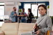 © DC Studio - Portrait of young woman holding beer bottle after hours in office, celebrating with workmates. Happy person enjoying leisure activity and party after work, having alcoholic drinks.
