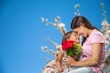 © BillionPhotos.com - Happy woman and child hold flowers. Mothers day