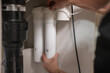 © Михаил Решетников - The technician changes water filters.
