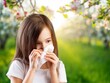 © BillionPhotos.com - Brunette girl sneezing in a tissue on spring background