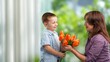 © BillionPhotos.com - Happy women's day. Child congratulating mom with flowers.