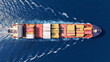 © aerial-drone - Aerial drone drone point of view photo above partial loaded container ship with colorful containers overlooking deep blue sea near logistics port