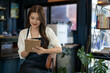 © apichat - Young asian woman barista writing order in coffee shop