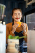 © apichat - Barista woman enjoying coffee aroma at cafe