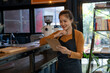 © apichat - Female small business owner checking inventory in coffee shop