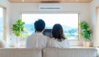 © 健 板澤 - テレビ画面を眺める夫婦の後ろ姿のポートレート