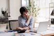 © David - Young Asian Businesswoman Suffering from Neck Pain While Working on Laptop at Office Desk