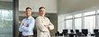 © insta_photos - Portrait of two happy business men, confident professional executive leaders partners work team, smiling male company managers looking at camera standing back to back with arms crossed in office.