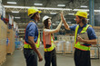 © ฺฺฺBoonterm - Group happy workers in the warehouse greeted each other with high-fives showing unity, encouragement cooperation and good spirits among employees in the warehouse organization.