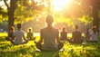 © Juri_Tichonow - Group of people sitting in lotus pose practicing meditation on green grass in park during bright golden sunset