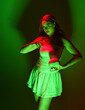 © faestock - Close up portrait female model with red hair, white dress, holding halloween human bone skull, gestural poses casting magical spell. Isolated figure, spooky green shadow silhouette studio lighting.