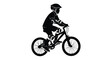 © DS - Boy riding a bicycle outdoors depicted in a striking silhouette