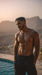 © CHAWAPON - Handsome male model standing shirtless by the pool with a breathtaking mountainous landscape behind him in the serene environment at sunset.