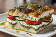 © britaseifert - Large square olive oil focaccia sandwich with cream cheese, pesto, tomato slices and cucumbers