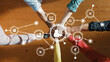 © InfiniteFlow - This image captures a diverse group of hands coming together, symbolizing teamwork and digital connectivity in a modern workspace, showcasing unity and innovative collaboration. Amity