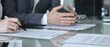 © rogerphoto - Business people reading and discussing contract terms, financial agreement, and legal paperwork during a negotiation.