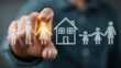 © qazi - Business professional touching glowing happy family home icon on transparent digital screen in modern living room setting, representing family security planning strategy