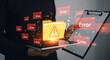 © Afsana - Hands holding tablet with glowing yellow warning folder and red error alerts