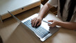 © Elder Stidio - closeup hand Young woman holding credit card and using laptop computer. Businesswoman or entrepreneur working at home. Online shopping, e-commerce, internet banking, working from home concept