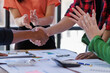 © David - A focused team engages in a discussion over business strategies, highlighting important documents and charts that reflect their ideas and plans for success.