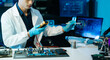 © Nuttapong punna - Technician testing computer motherboard with multimeter in a high-tech electronics lab, analyzing hardware diagnostics, cybersecurity systems