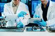 © Nuttapong punna - Engineers repairing computer hardware and analyzing data storage systems in a high-tech lab with cybersecurity monitoring, diagnostics, and digital technology
