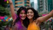 © forenna - Women celebrating Holi festival throwing vibrant purple and orange powders in urban park with spring flowers blooming, ideal for cultural celebration, springtime traditions, community joy, and