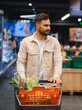 © Serhii - Man shopping for healthy food in supermarket aisle