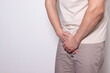 © Alina_Stor - Man suffering from painful urination symptoms holding crotch. Concept of bladder infection, prostatitis, urinary tract disease or sexually transmitted infection. Copy space
